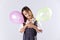 Little girl holding color ballons