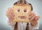 Little girl holding in front of his face, a happy slice of bread