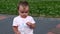 Little girl holding a plastic water bottle in the street