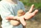 Little girl holding a stone in her hand. The stone is a close-up. The girl does not focus