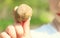 Little girl holding a stone in her hand. The stone is a close-up. The girl does not focus