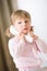 Little girl holding telephone receiver calling