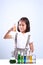 Little girl holding a test tube with liquid scientist chemistry and science