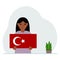 A little girl is holding a Turkish flag in his hands. Concept for demonstration, national holiday, Turkey day or