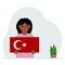 A little girl is holding a Turkish flag in his hands. Concept for demonstration, national holiday, Turkey day or