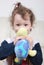 Little girl holding turtle plush