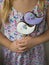 Little girl holding violet and white cookies with the birds