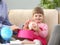 Little girl holds in arms piggy bank with plans for future