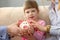 Little girl holds in arms piggy bank with plans for future