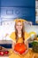 Little girl holds big pumpkin in kitchen at home. Harvesting. Healthy nutrition, vegetarianism, vitamins, vegetables. Cute child g