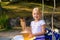 A little girl holds in her hands a delicious and beautiful ice cream in a waffle with sprinkles and sweets. Palanga, Lithuania,