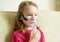 Little girl holds inhaler mask at home