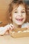 Little girl holds open box of corrugated cardboard with cookies