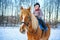 Little girl on a horse in winter, horseback riding