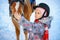 Little girl on a horse in winter, horseback riding