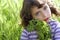 Little girl hug green plant meadow spikes