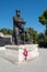 A little girl at a huge monument to the Emperor of Russia Alexander III in Livadia Park, 09/04/2019, Yalta, Crimea