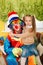 Little girl hugging a cheerful clown.