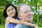 Little girl hugging her grandfather outdoors, diversity