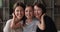 Little girl hugging mother and older grandmother posing for camera