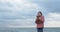 Little girl hugs a teddy bear on the beach