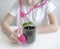 Little girl imagining herself as doctor while playing with pink stethoscope. Young plants. Caring for a new life. Climate change