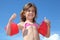 Little girl with inflatable armbands thumbs up