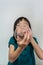 Little Girl inflate a Pink Balloon using white plastic straw  on white