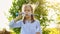 Little girl inflate soap bubbles on a picnic