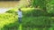 Little girl inflate soap bubbles on a picnic