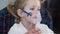 Little Girl Inhales with Face Mask of Inhaler