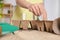 Little girl inserting cards with names of vegetable seeds into peat pots indoors, closeup