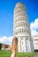 Little girl on italian vacation near the famous Leaning Tower of Pisa, Italy