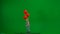 Little girl in jeans overall and ponytail with red helium balloons walking on chroma key green screen isolated