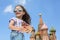 Little girl in jeans with suspenders with a miniature cathedral