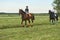 Little girl jockey and her coach ridding a horse