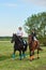 Little girl jockey and her coach ridding a horse