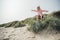 Little Girl Jumping Over a Sand Dune