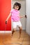 Little girl jumping rope at home