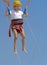 A little girl jumps high on a trampoline with rubber ropes again