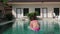 Little girl jumps in a swimming pool. funy time in summer holiday