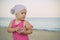 Little girl in kerchief on the sea in summer