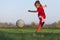 Little girl kicks soccer ball