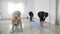 Little girl kid attending her first yoga class with her mother and other middle aged women in slow motion in a fitness studio -