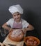Little girl kneads dough