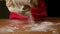 Little girl kneads dough. Child prepares dough for pie, dumplings, cookies.