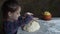 Little girl kneads the dough and smeared hands.