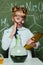 Little girl in lab coat holding digital tablet in science laboratory