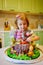 little girl with a large cake with figures of fairy-tale characters