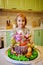 little girl with a large cake with figures of fairy-tale characters